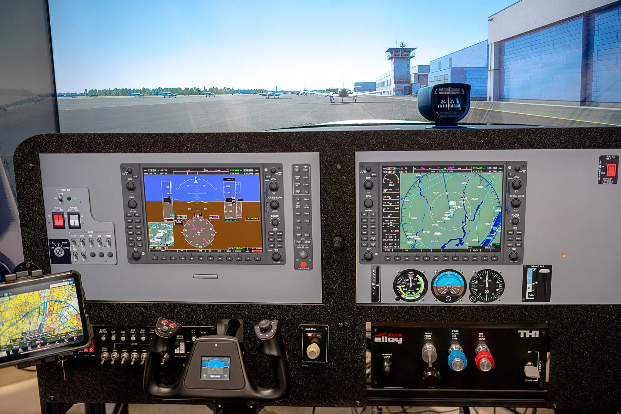 Glass-cockpit panel and wraparound visuals in the SG-2 simulator at Solid Ground Aviation in Fort Meade, MD