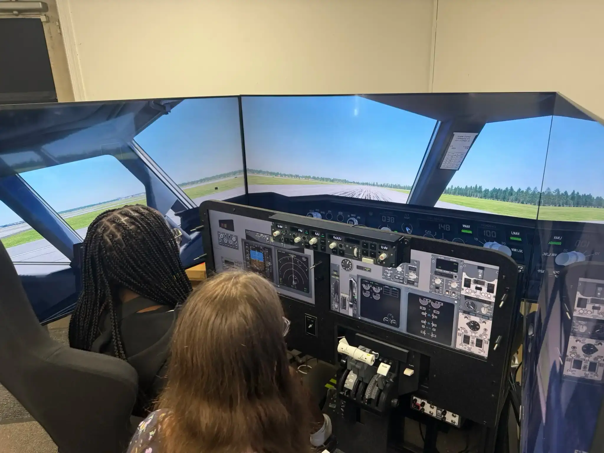 Flight students reviewing flight plan after simulator session at Solid Ground Aviation Maryland