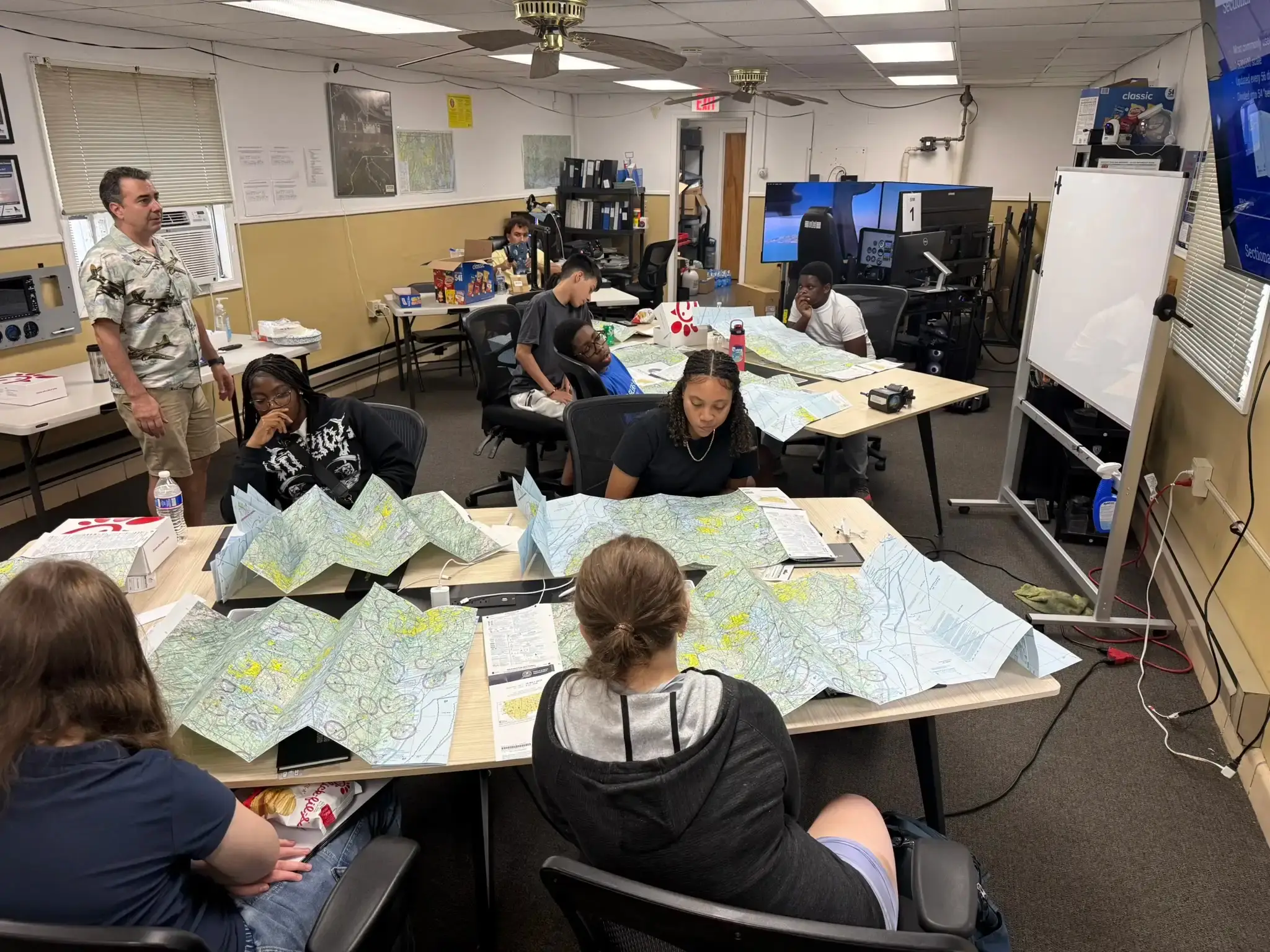 Kids reading aeronautical sectional charts at Solid Ground Aviation Fort Meade
