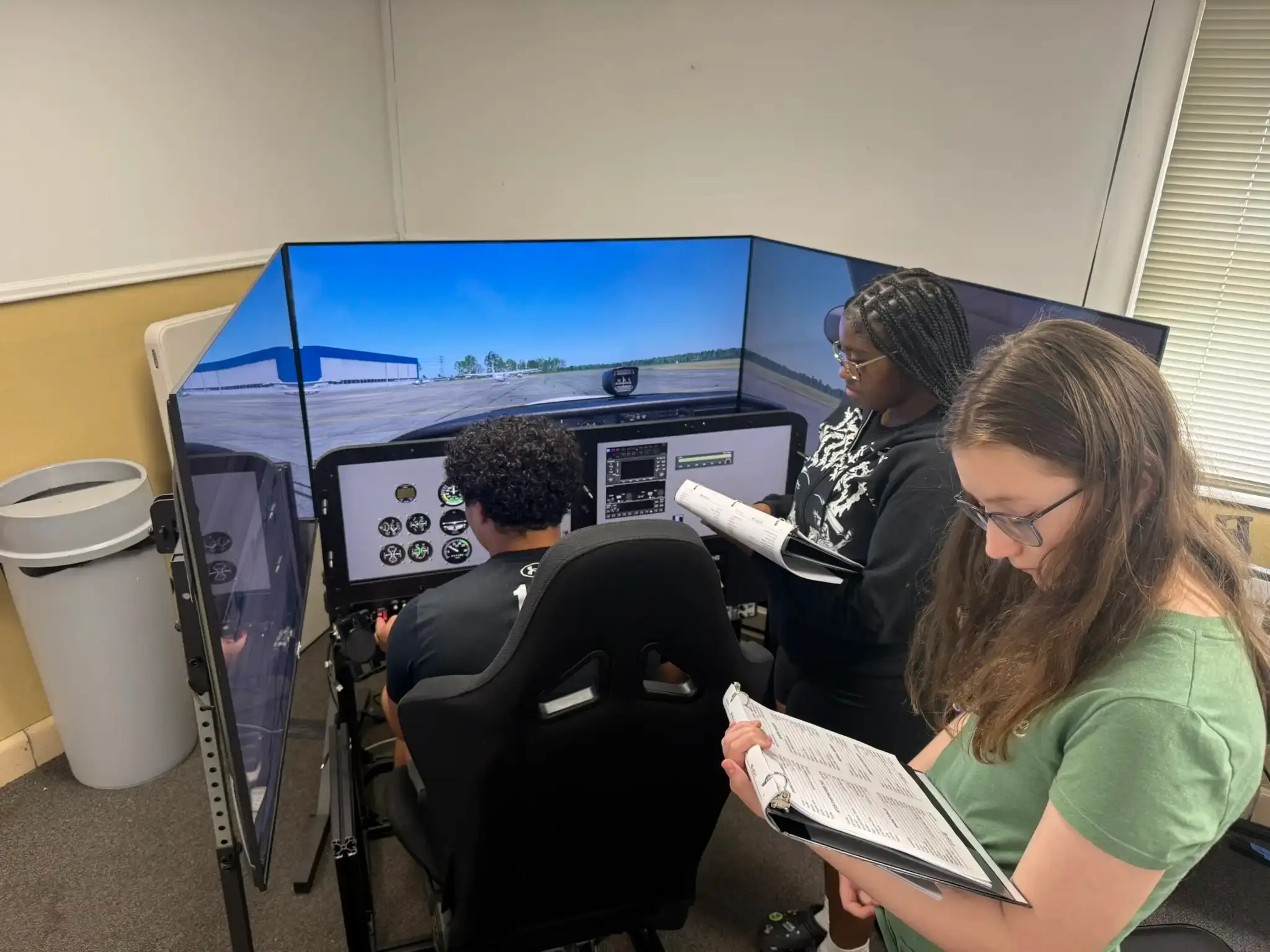 Young student flying basic flight simulator at Solid Ground Aviation in Fort Meade MD