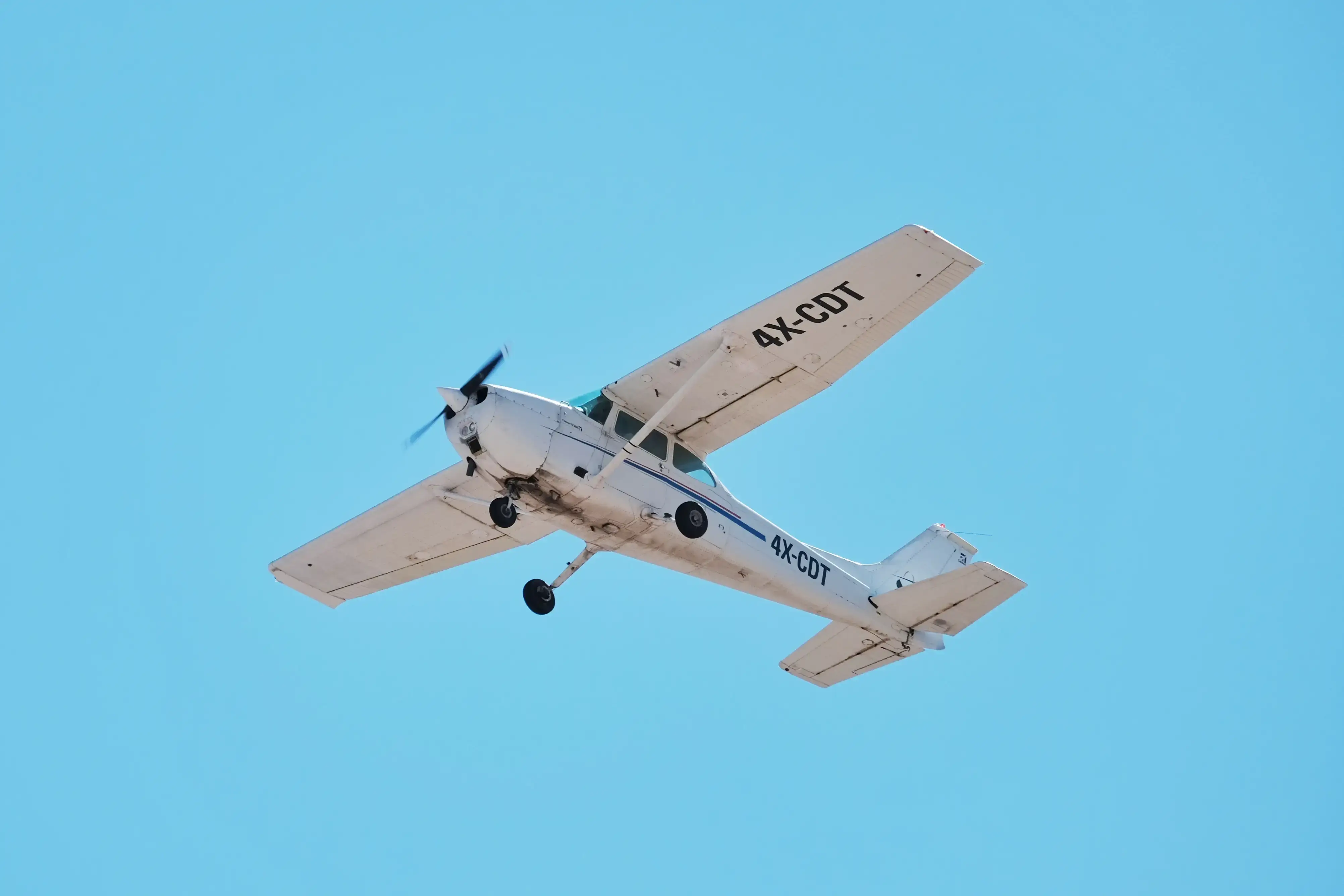 Close-up of a Cessna 172 nose and cockpit at sunset