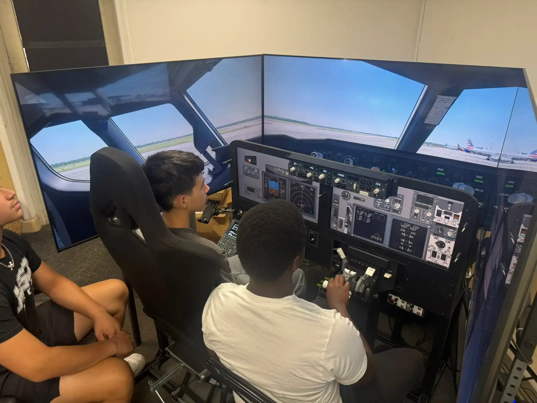 Young aviators cockpit training in AATD flight simulator at Solid Ground Aviation Tipton Airport MD