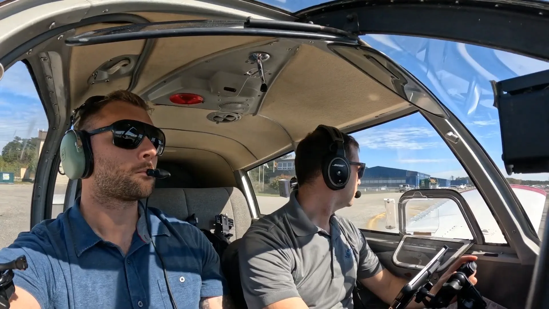 Two pilots inside an airplane during takeoff