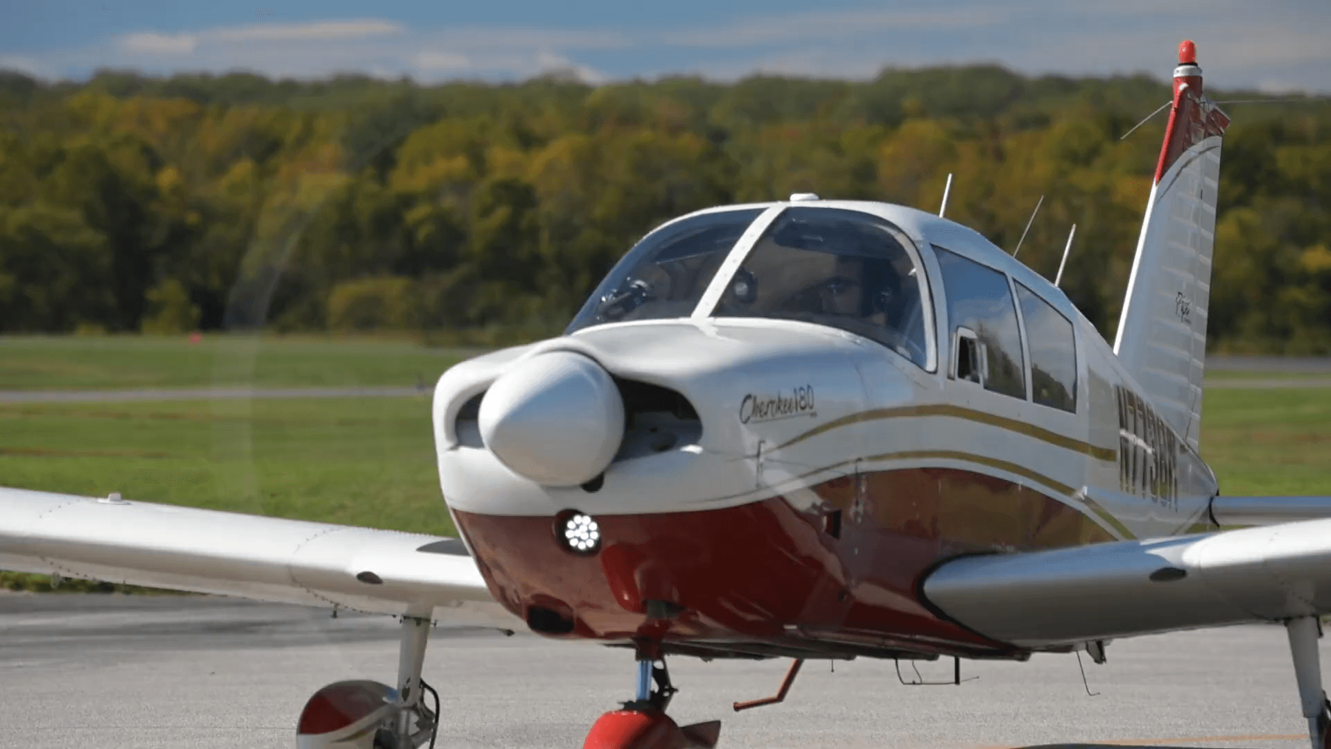 Front view of a training aircraft preparing for takeoff at an airfield